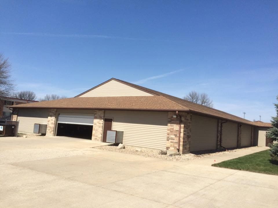Brick commercial building with a broad new hip roof