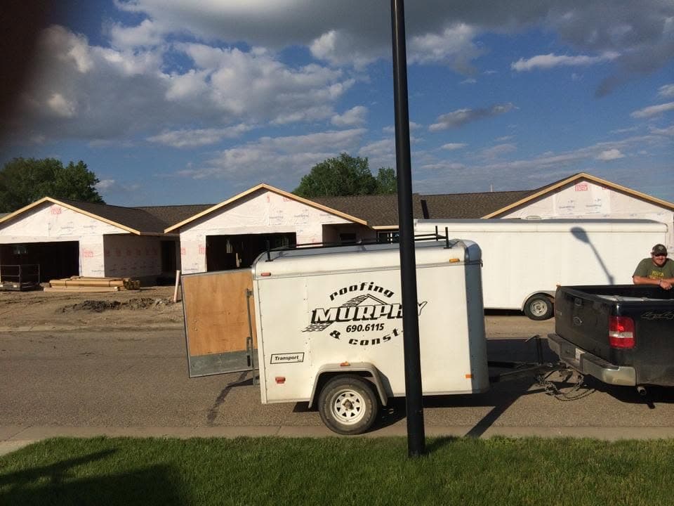 Murphy Roofing and Construction job trailer hitched to a pickup
