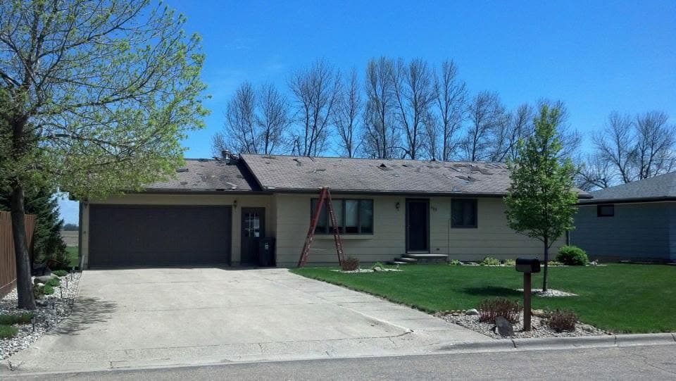 Wide single-story ranch under a uniform new shingle roof
