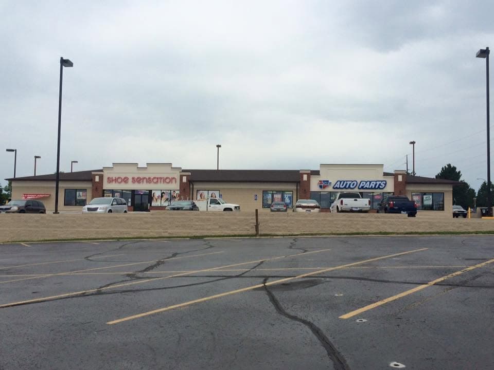 Single-story retail strip with a fresh shingle roof